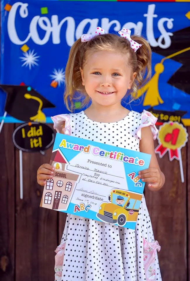 Young child holding an award certificate at an Onix Edu activity